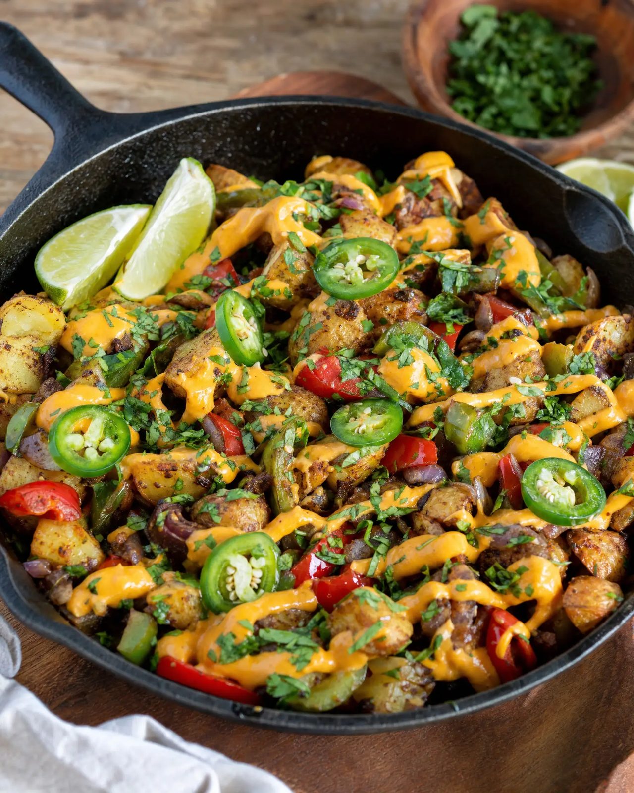 Skillet of fiesta potatoes with cheez sauce