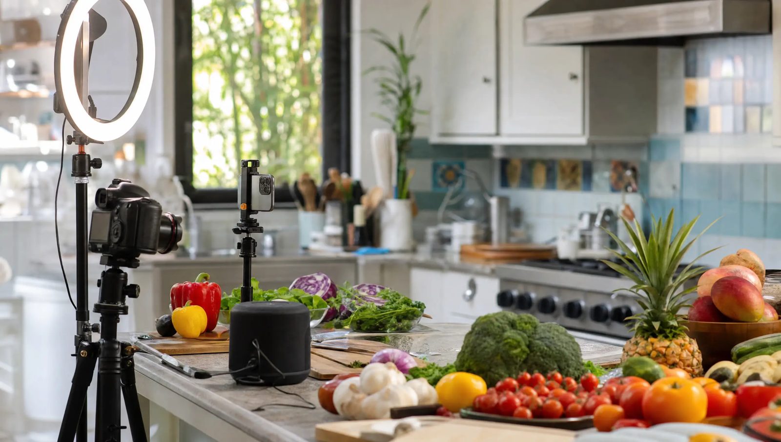 Camera and ring light set up in a bright kitchen